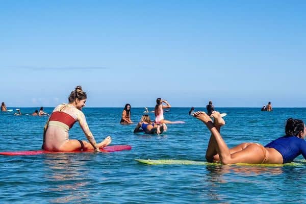 Sustainable swimwear - women on surfboards wearing seea swimwear