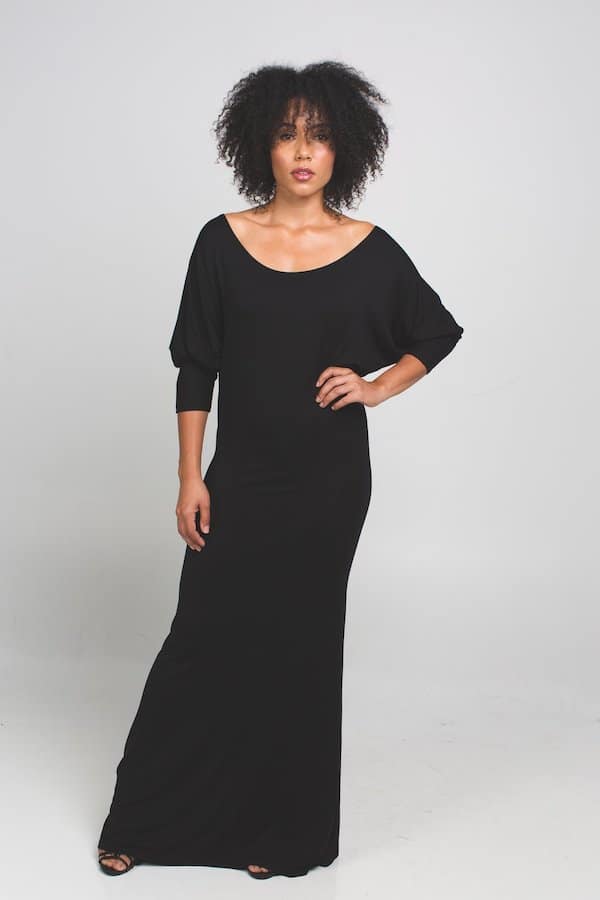 woman standing in long black dress by taylor jay collection