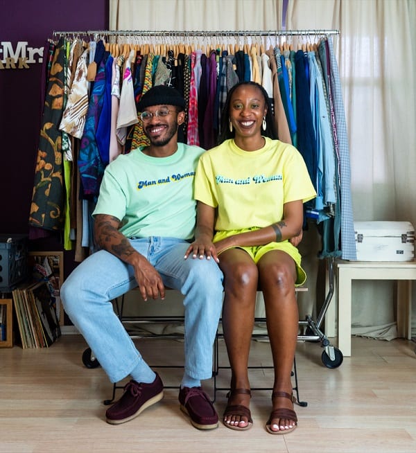 Man and woman sitting down in front of clothes maw supply