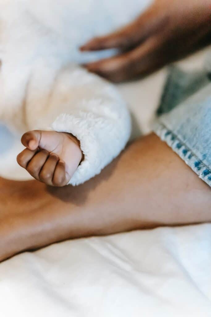 Baby arm on person's leg